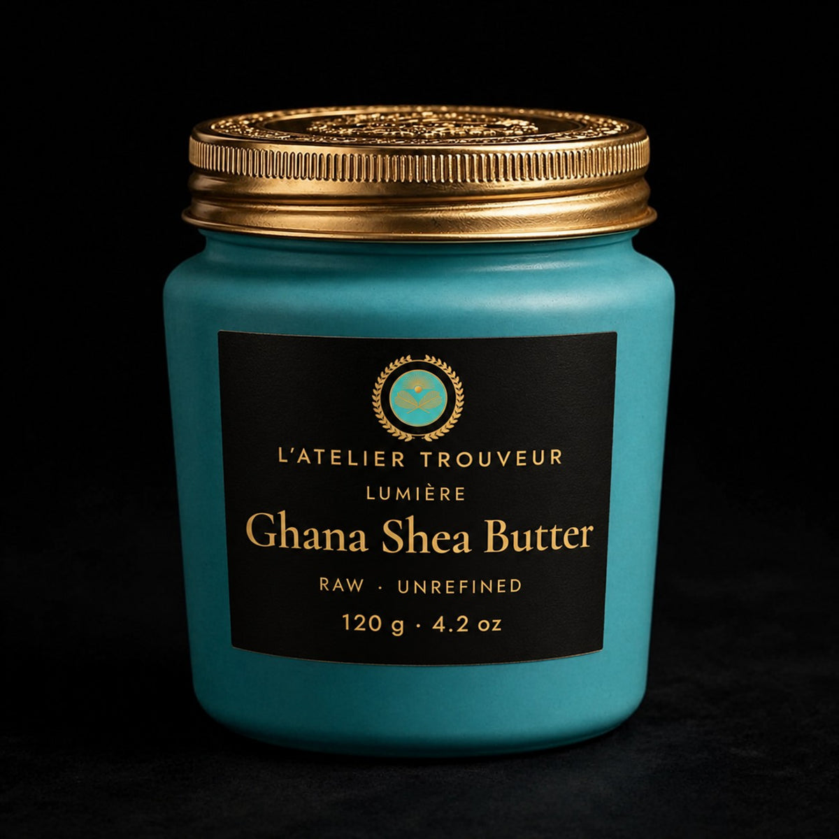 Ghana Shea Butter turquoise jar with black and gold medallion label on black